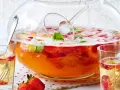 Erfrischendes Bowle-Rezept mit Erdbeeren und Minze in einer großen Glasbowle, bereit zum Servieren in Gläsern.