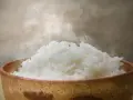 Dampfender Reis in einer Schale. Ein Beweis, dass Reis gesund ist und eine nahrhafte Mahlzeit darstellt.