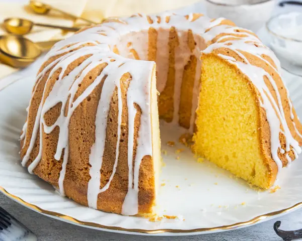 Ein saftiger Gugelhupf, verziert mit einem weißen Zuckerguss, der an Vanillepudding erinnert. Perfekt für jeden Anlass!