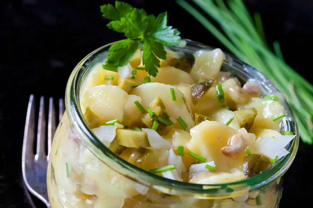 Klassischer Kartoffelsalat zum Grillen im Glas, garniert mit Petersilie und Schnittlauch. Perfekt als Beilage!
